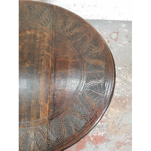 22 - A 17th century style carved oak drop leaf gate leg oval occasional table with single drawer - approx... 