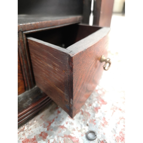 28 - A George III mahogany bow fronted wall hanging corner cabinet with brass 'H' hinges - approx. 112cm ... 