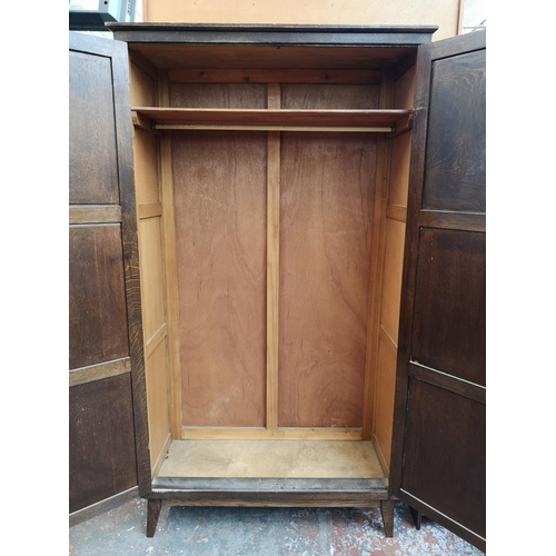 29 - A mid 20th century oak gent's wardrobe - approx. 166cm high x 92cm wide x 38cm deep