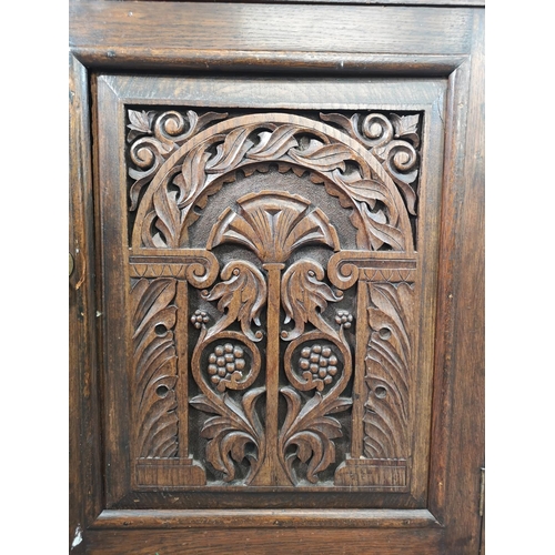 33 - An early 20th century carved oak single door cabinet with upper drawer - approx. 97cm high x 66cm wi... 