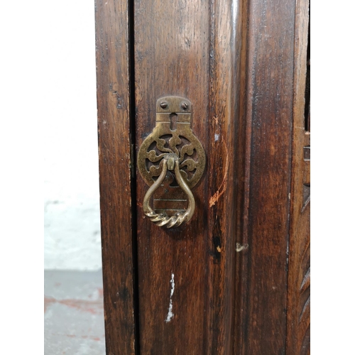 33 - An early 20th century carved oak single door cabinet with upper drawer - approx. 97cm high x 66cm wi... 