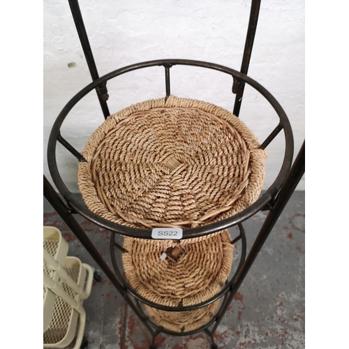 34 - Two three tier vegetable racks, one wrought iron and rattan approx. 140cm high and one cream metal o... 