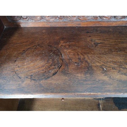 38 - A late 19th/early 20th century Macclesfield School of Carving oak writing desk with fall front, thre... 