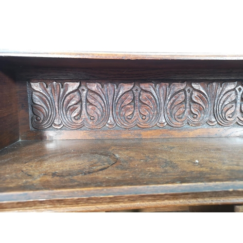 38 - A late 19th/early 20th century Macclesfield School of Carving oak writing desk with fall front, thre... 