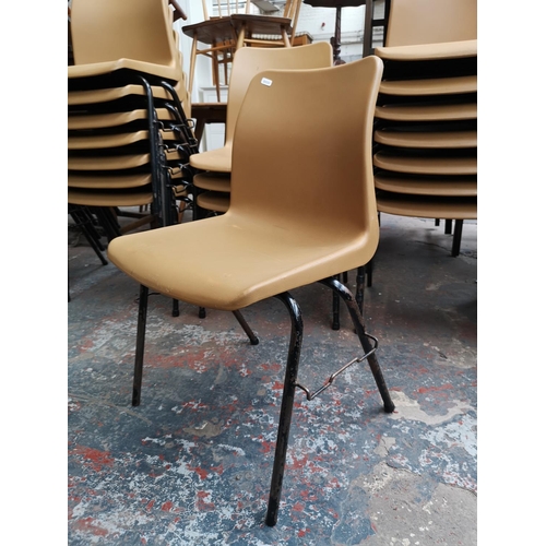 41 - Twenty nine brown plastic and black metal school stacking chairs