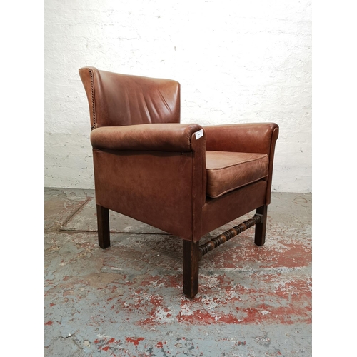 44 - A mid 20th century brown leather and oak armchair - approx. 84cm high x 67cm wide x 65cm deep