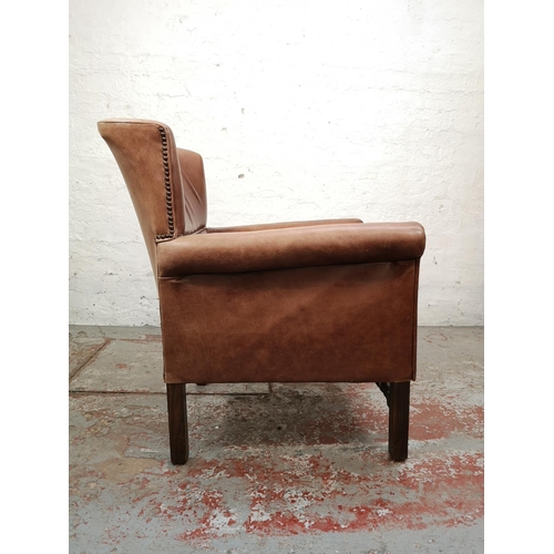 44 - A mid 20th century brown leather and oak armchair - approx. 84cm high x 67cm wide x 65cm deep