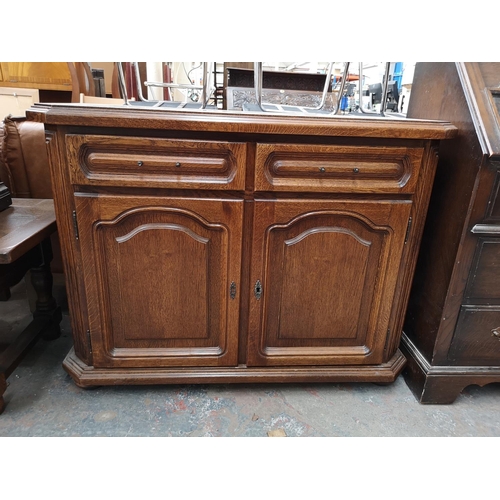 52 - Seven pieces of oak furniture to include bureau, sideboard, two drawer coffee table, magazine rack, ... 