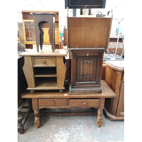 52 - Seven pieces of oak furniture to include bureau, sideboard, two drawer coffee table, magazine rack, ... 