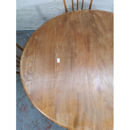 55 - An Ercol blonde elm and beech drop leaf dining table with four Ercol model 391 Windsor dining chairs... 