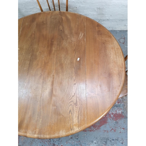 55 - An Ercol blonde elm and beech drop leaf dining table with four Ercol model 391 Windsor dining chairs... 