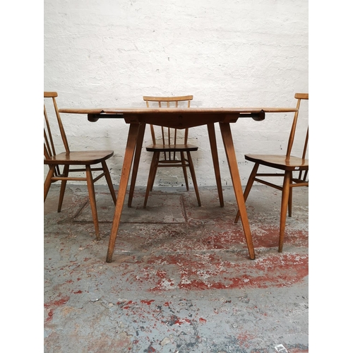 55 - An Ercol blonde elm and beech drop leaf dining table with four Ercol model 391 Windsor dining chairs... 