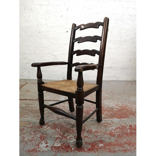 6 - A 19th century style oak ladder back child's armchair with rush seat - approx. 76cm high x 42cm wide... 