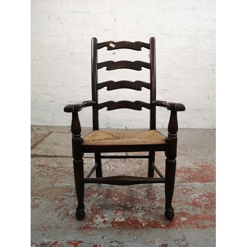 6 - A 19th century style oak ladder back child's armchair with rush seat - approx. 76cm high x 42cm wide... 