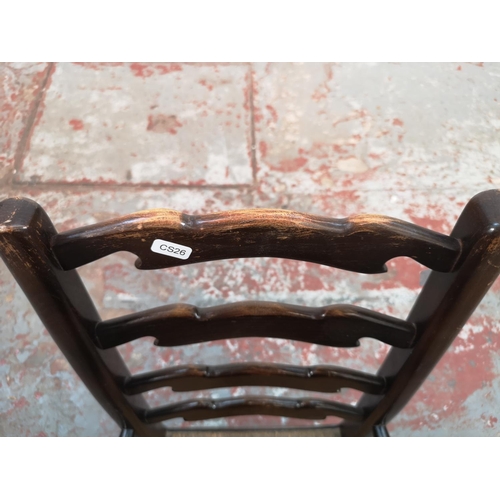 6 - A 19th century style oak ladder back child's armchair with rush seat - approx. 76cm high x 42cm wide... 