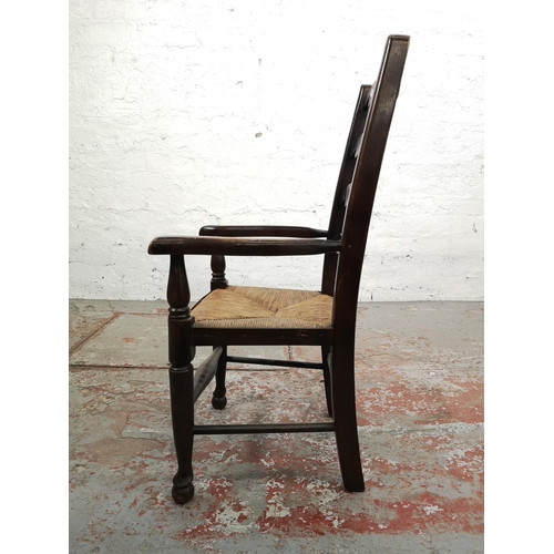 6 - A 19th century style oak ladder back child's armchair with rush seat - approx. 76cm high x 42cm wide... 