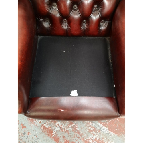 61 - An oxblood leather Chesterfield wing back armchair with cabriole supports - approx. 112cm high x 75c... 