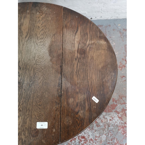 63 - Three pieces of furniture comprising oak swivel top joint occasional table, copper topped coffee tab... 