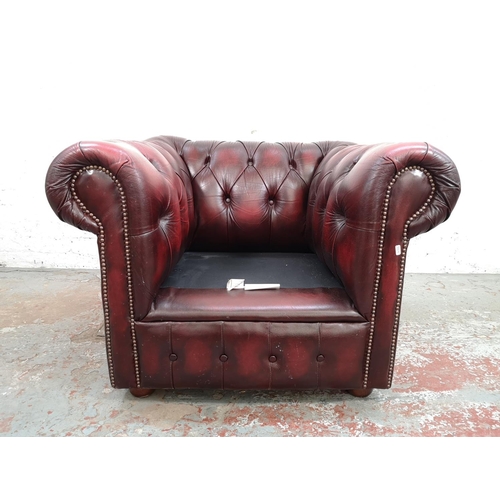 66 - An oxblood leather Chesterfield club chair - approx. 72cm high x 100cm wide x 83cm deep