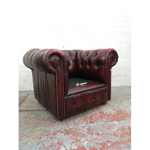 66 - An oxblood leather Chesterfield club chair - approx. 72cm high x 100cm wide x 83cm deep