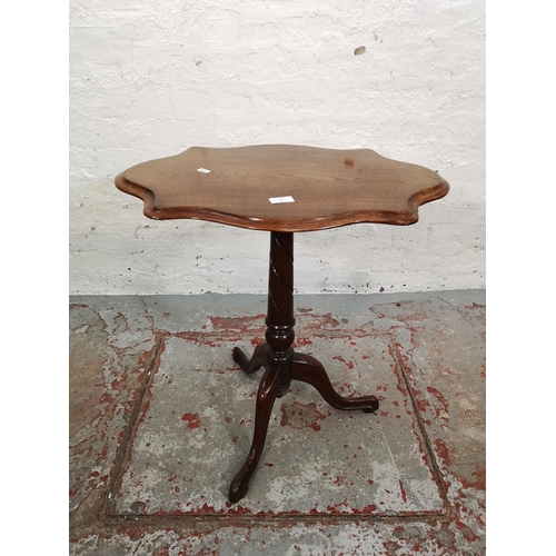 68 - An early 20th century mahogany serpentine side table with tripod pedestal support - approx. 65cm hig... 