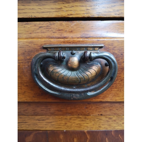 75 - An Art Nouveau oak sideboard with two upper drawers, two outer cupboard doors, central glazed door w... 