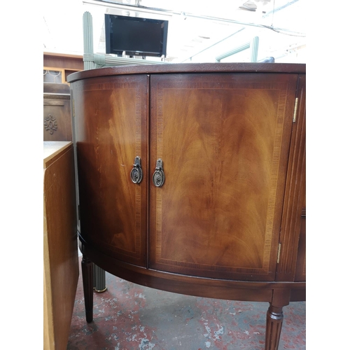 81 - A Strongbow Furniture mahogany bow fronted sideboard with three central drawers and two outer cupboa... 