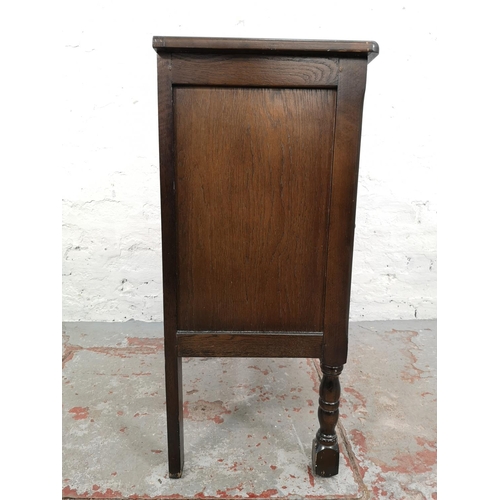 85 - An oak side cabinet with two doors and upper drawer - approx. 73cm high x 61cm wide x 32cm deep