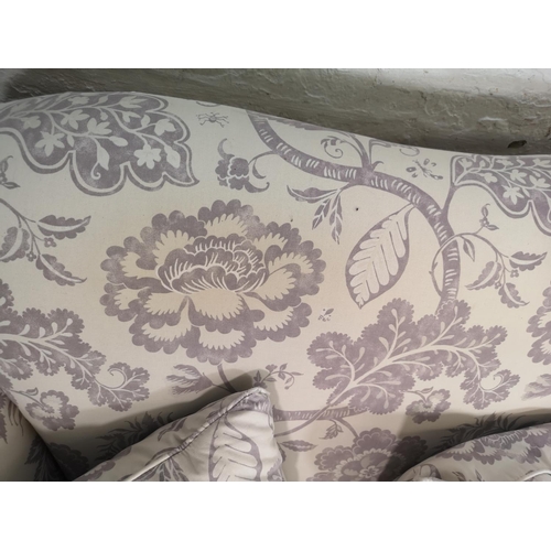 92 - A Wesley Barrell white and purple floral upholstered three seater sofa with castors - approx. 93cm h... 