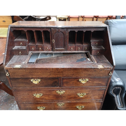 94 - A George III oak bureau - approx. 102cm high x 87cm wide x 50cm deep