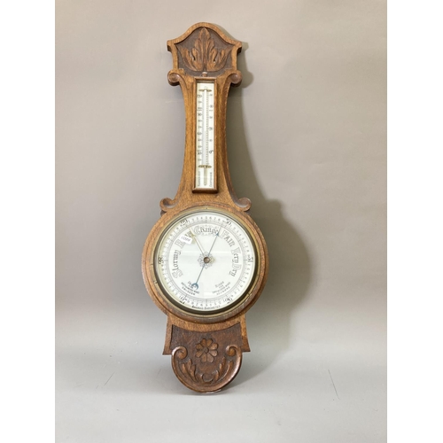 1632 - An early 20th century oak cased barometer and thermometer with carved floral design - approx. 81.5cm... 