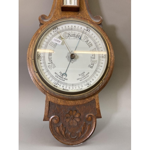 1632 - An early 20th century oak cased barometer and thermometer with carved floral design - approx. 81.5cm... 