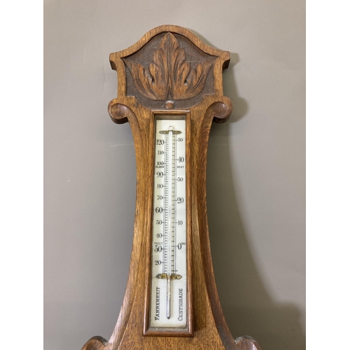 1632 - An early 20th century oak cased barometer and thermometer with carved floral design - approx. 81.5cm... 