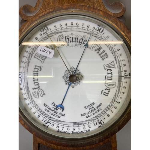 1632 - An early 20th century oak cased barometer and thermometer with carved floral design - approx. 81.5cm... 