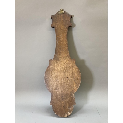 1632 - An early 20th century oak cased barometer and thermometer with carved floral design - approx. 81.5cm... 