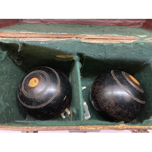 1681 - A leather cased pair of vintage Thomas Taylor of Glasgow lignum vitae Crown Green bowls