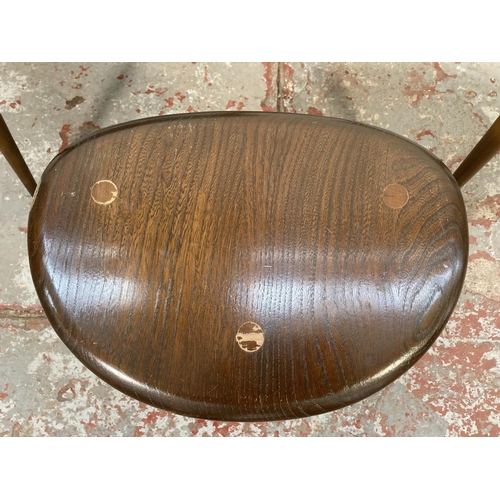 80 - An Ercol dark elm and beech pebble shaped nest of three tables