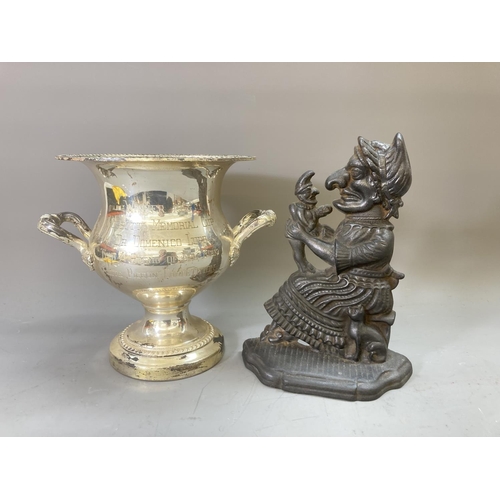 60 - Two pieces of metalware, one cast metal Judy doorstop - approx. 28cm high and one silver plated trop... 