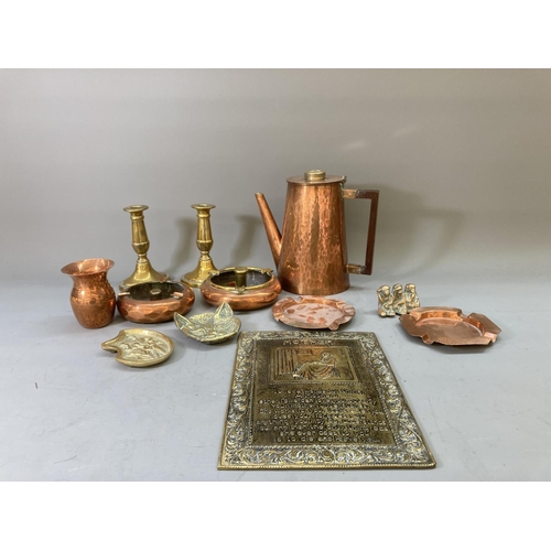 63 - A collection of copper and brassware to include a pair of 16cm candlesticks, kettle, ashtrays etc.