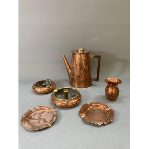 63 - A collection of copper and brassware to include a pair of 16cm candlesticks, kettle, ashtrays etc.