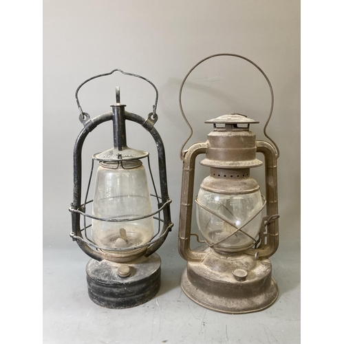 68 - Two vintage storm lanterns, one British made approx. 40cm high and one Dietz approx. 35cm high