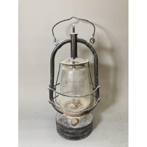 68 - Two vintage storm lanterns, one British made approx. 40cm high and one Dietz approx. 35cm high