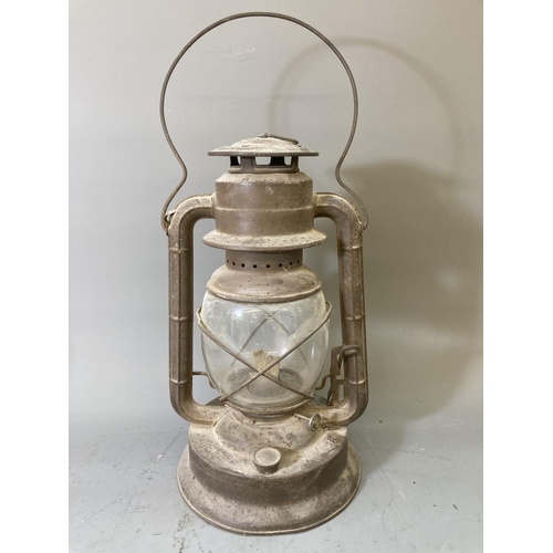 68 - Two vintage storm lanterns, one British made approx. 40cm high and one Dietz approx. 35cm high