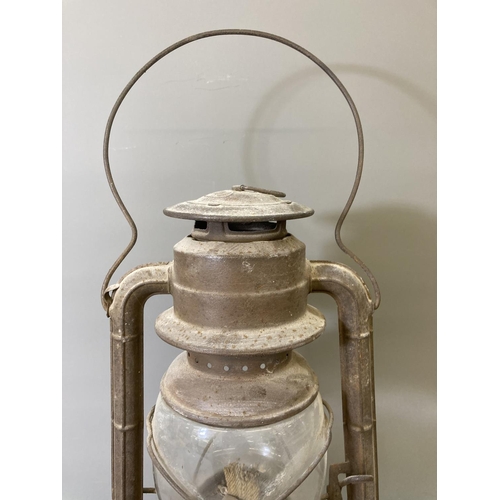 68 - Two vintage storm lanterns, one British made approx. 40cm high and one Dietz approx. 35cm high