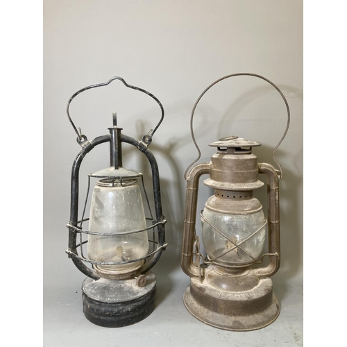 68 - Two vintage storm lanterns, one British made approx. 40cm high and one Dietz approx. 35cm high