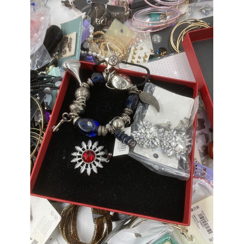 159 - A box containing a large quantity of assorted costume jewellery to include bangles, earrings, neckla... 