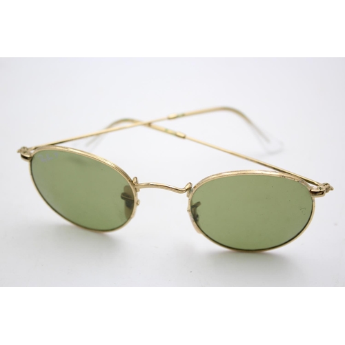 138 - A cased pair of classic Ray-Ban gold tone round metal sunglasses with polarized lenses