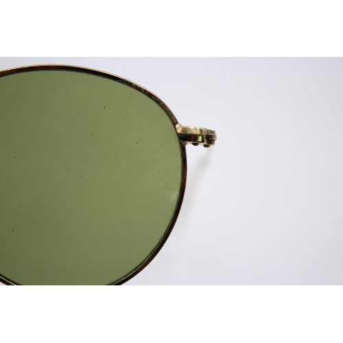 138 - A cased pair of classic Ray-Ban gold tone round metal sunglasses with polarized lenses