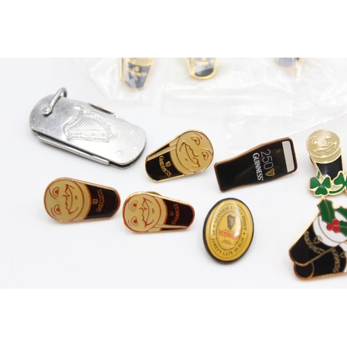 1438 - Fourteen assorted Guiness advertising pin badges and one pen knife