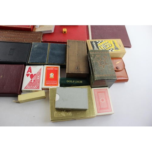 69 - A collection of assorted playing cards and games to include cribbage, dice, dominoes etc.